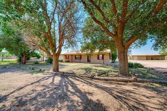 ranch-style house with brick siding and fence