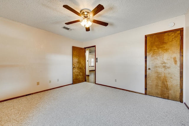 unfurnished room featuring carpet flooring, a textured ceiling, and ceiling fan