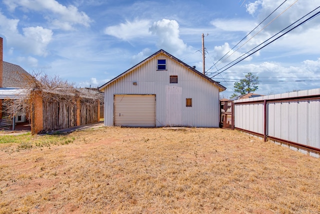 4902 Leisure Dr, Midland, TX 79703 - rear view of house featuring a garage, an outdoor structure, and driveway
