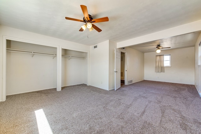 4902 Leisure Dr, Midland, TX 79703 - unfurnished bedroom featuring two closets, carpet flooring, and a ceiling fan