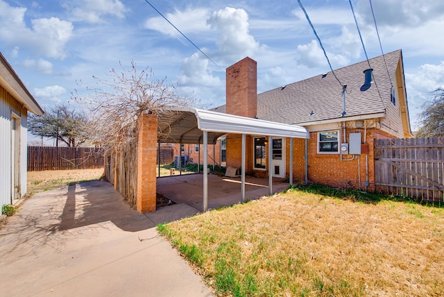4902 Leisure Dr, Midland, TX 79703 - rear view of property featuring a chimney, a fenced backyard, and brick siding