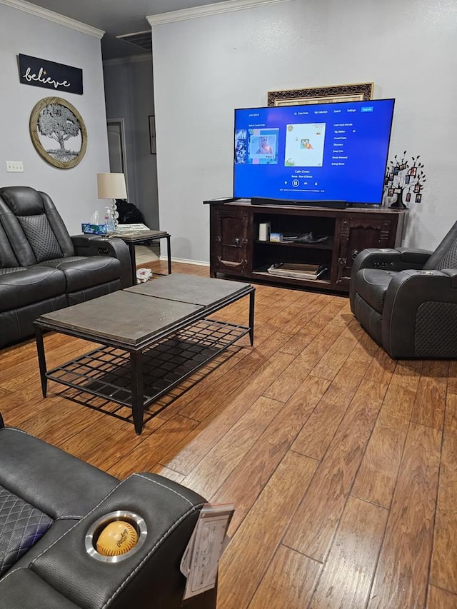 living room with crown molding and hardwood / wood-style flooring