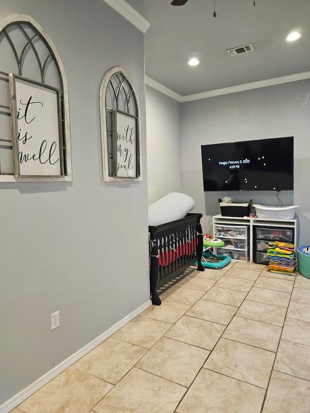 tiled bedroom featuring crown molding and a nursery area