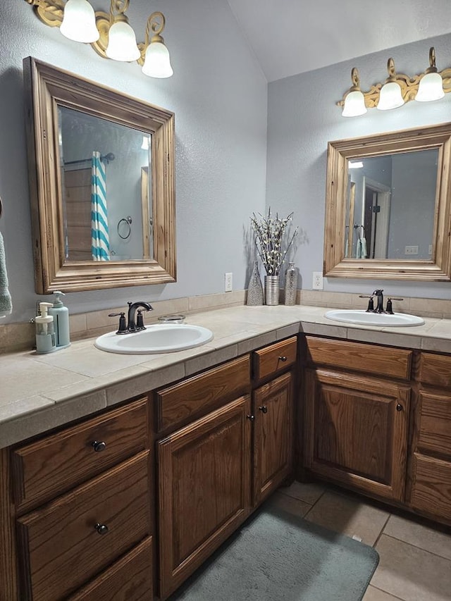 bathroom featuring vaulted ceiling, vanity, and tile patterned flooring