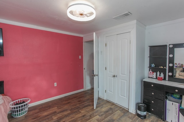 interior space featuring visible vents, baseboards, and wood finished floors