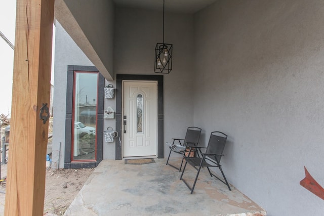 entrance to property featuring stucco siding