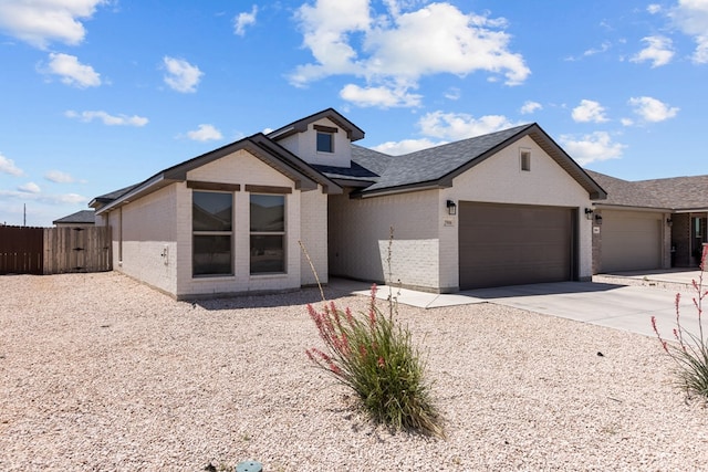 2906 Yellowstone Ct, Midland, TX 79705 - view of front of home featuring brick siding, an attached garage, concrete driveway, and roof with shingles