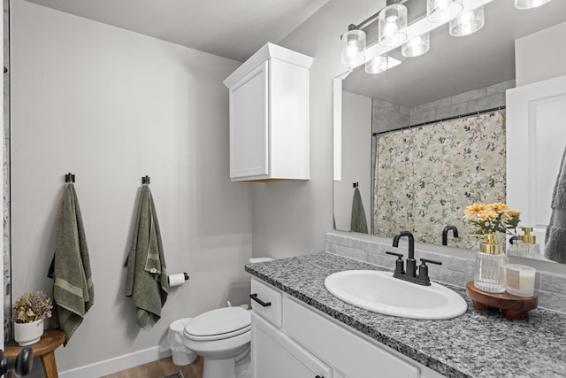 2906 Yellowstone Ct, Midland, TX 79705 - full bathroom with vanity, toilet, a shower with curtain, and wood finished floors