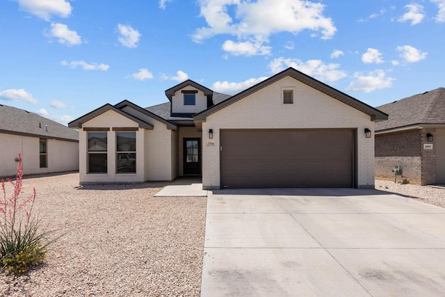 2906 Yellowstone Ct, Midland, TX 79705 - view of front of property featuring brick siding, driveway, and an attached garage