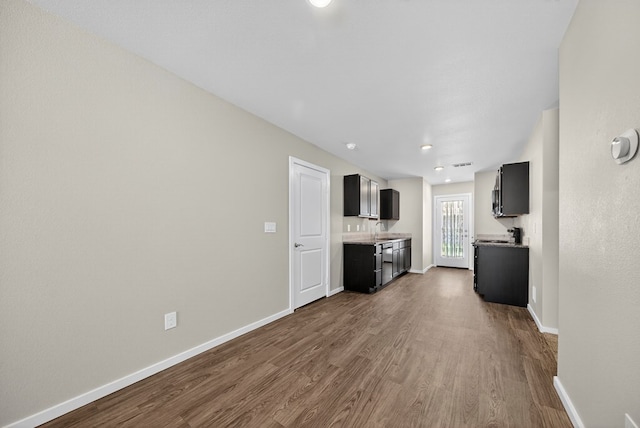 1317 Masquerade Blvd, Odessa, TX 79765 - unfurnished living room featuring dark wood-style floors and recessed lighting