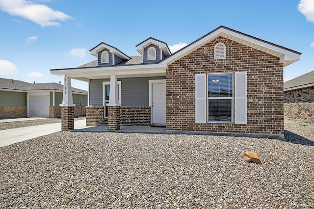 1317 Masquerade Blvd, Odessa, TX 79765 - view of front facade with brick siding, covered porch, and driveway