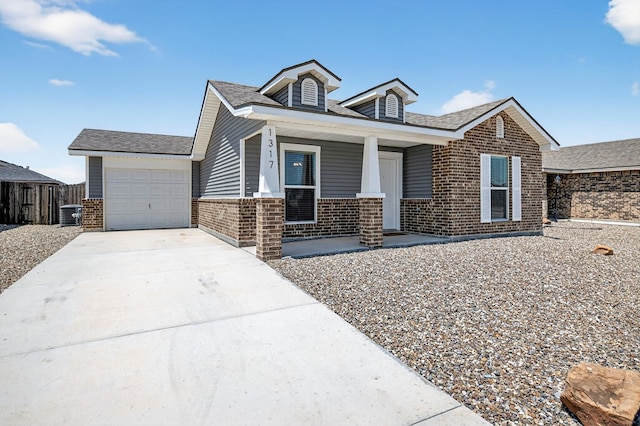 1317 Masquerade Blvd, Odessa, TX 79765 - view of front of house with brick siding, covered porch, an attached garage, and driveway