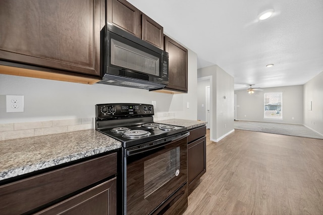 1317 Masquerade Blvd, Odessa, TX 79765 - kitchen with black appliances, dark brown cabinetry, light wood-type flooring, light countertops, and recessed lighting