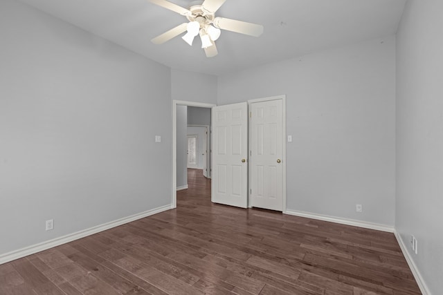 unfurnished bedroom featuring ceiling fan, baseboards, and wood finished floors