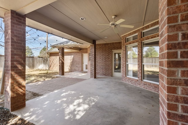 view of patio / terrace with ceiling fan and fence