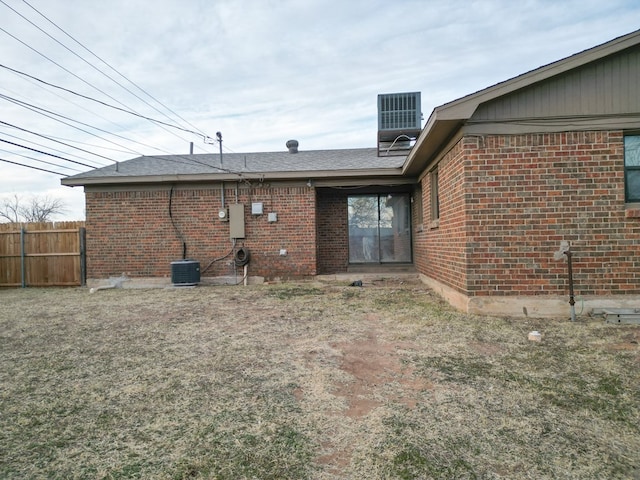 rear view of property featuring central AC