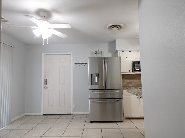 kitchen featuring white cabinetry, backsplash, light tile patterned floors, ceiling fan, and stainless steel fridge with ice dispenser