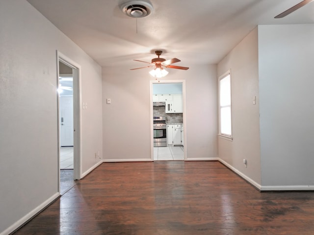 interior space with dark hardwood / wood-style floors and ceiling fan