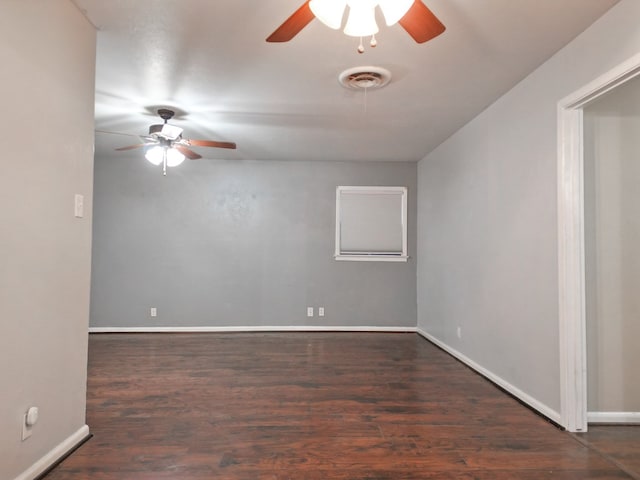 empty room featuring dark wood-type flooring and ceiling fan