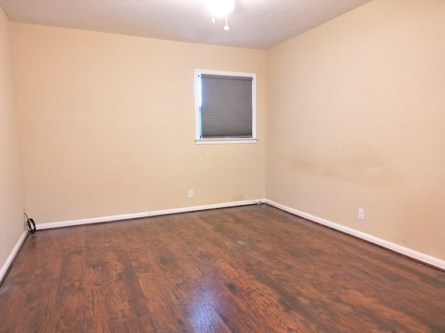 empty room with dark wood-type flooring