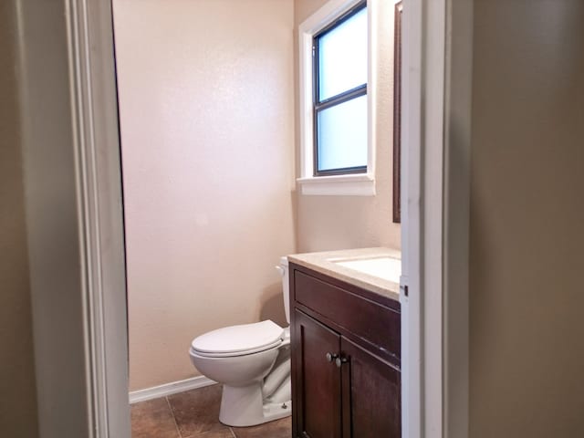 bathroom with vanity, toilet, and tile patterned flooring