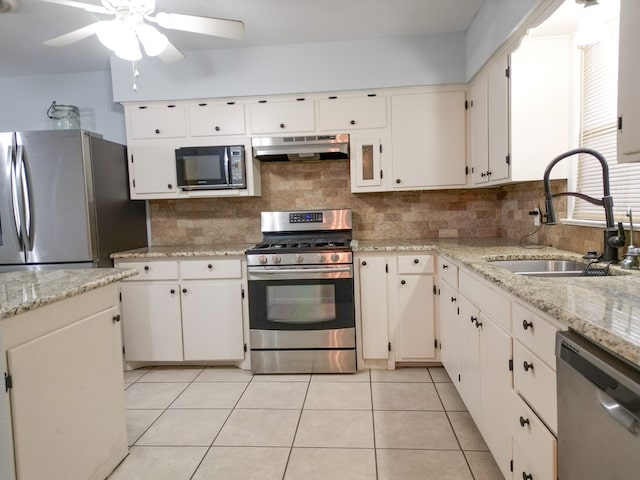 kitchen featuring stainless steel appliances, white cabinetry, and sink