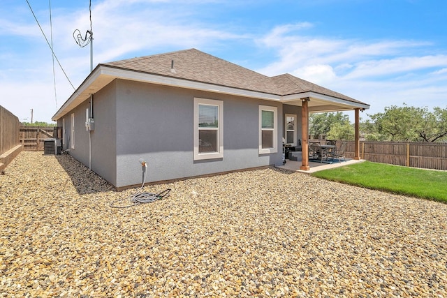 1404 Marijo, Big Spring, TX 79720 - back of house featuring a patio, a shingled roof, a fenced backyard, and stucco siding