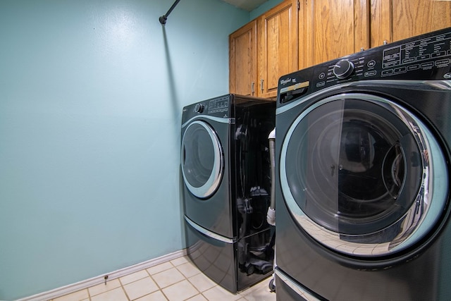 4404 Westminister Dr, Midland, TX 79707 - washroom with cabinet space, washing machine and clothes dryer, baseboards, and light tile patterned floors