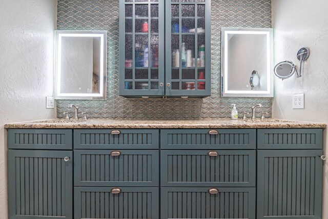 4404 Westminister Dr, Midland, TX 79707 - bar area with decorative backsplash, a sink, and a textured wall