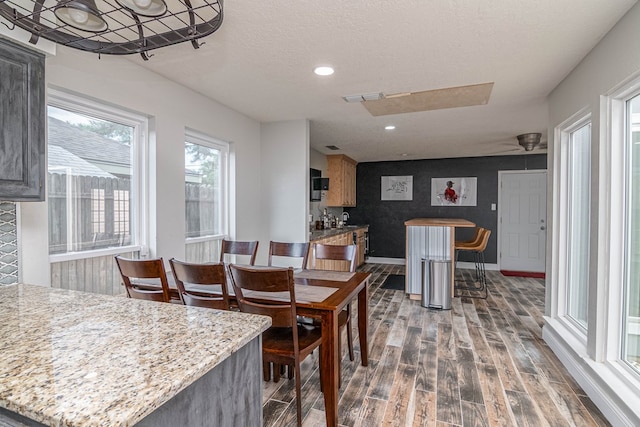 4404 Westminister Dr, Midland, TX 79707 - dining room with dark wood-type flooring, baseboards, recessed lighting, and a textured ceiling