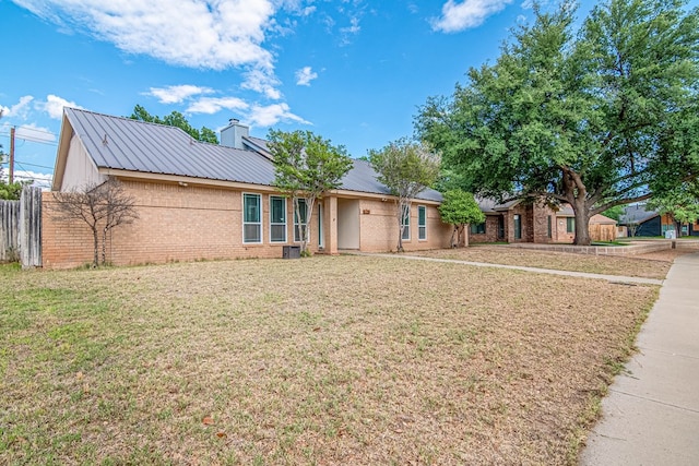 4404 Westminister Dr, Midland, TX 79707 - single story home with brick siding, metal roof, and a chimney