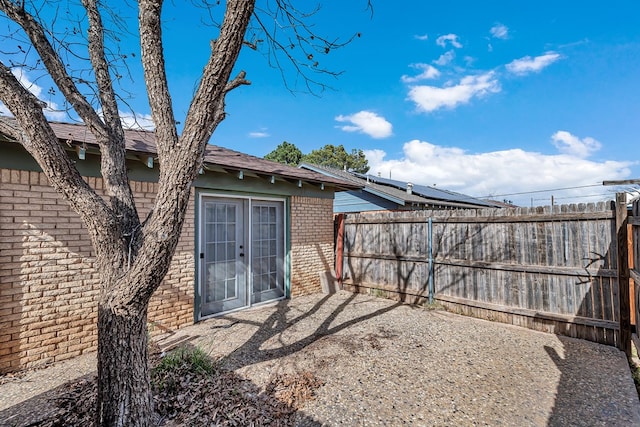 view of yard with french doors, a patio, and fence