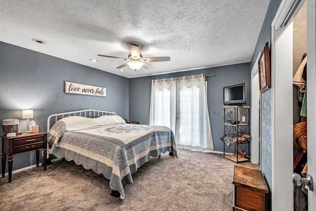 carpeted bedroom with a textured ceiling, a textured wall, baseboards, and ceiling fan