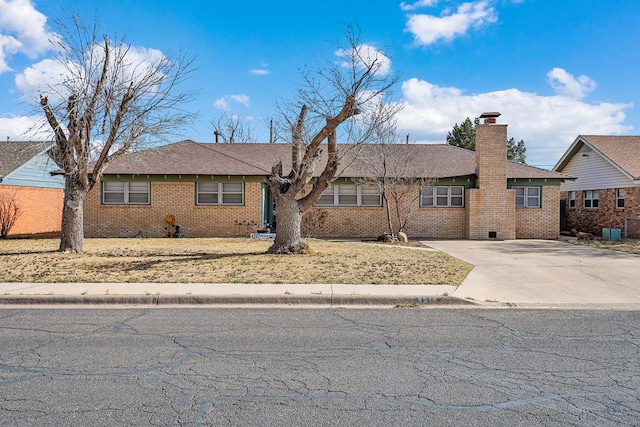 ranch-style home featuring brick siding, concrete driveway, and a chimney