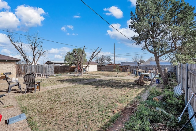 view of yard featuring an outbuilding and a fenced backyard