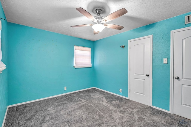 unfurnished bedroom featuring ceiling fan, carpet, visible vents, and a textured ceiling