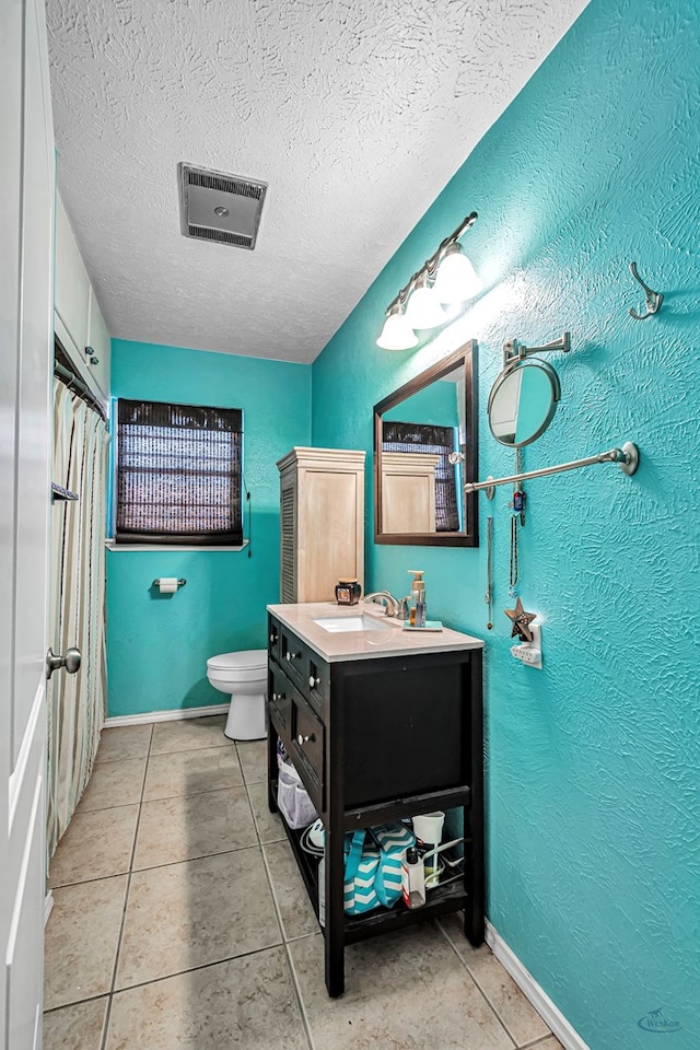 full bathroom featuring vanity, visible vents, a textured ceiling, tile patterned floors, and toilet