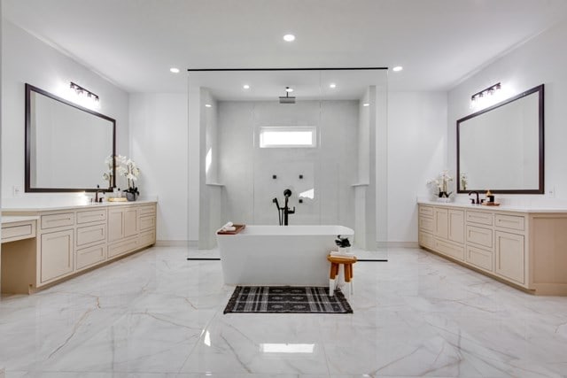 bathroom featuring a tub to relax in and vanity