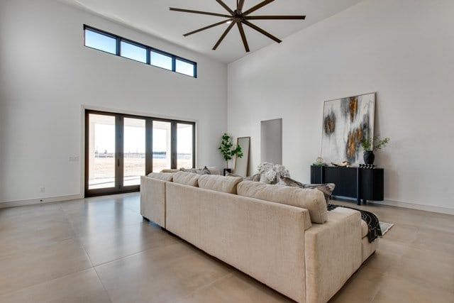 living room with a high ceiling and plenty of natural light