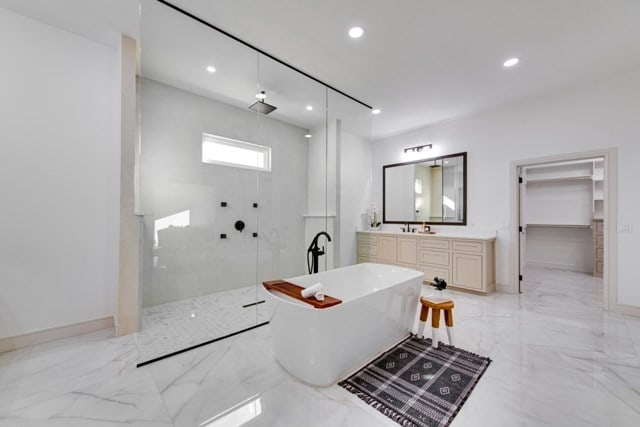 bathroom with vanity and independent shower and bath