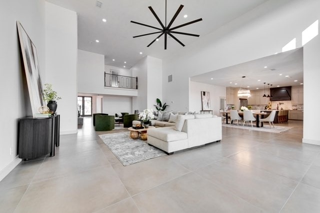 living room featuring a towering ceiling and an inviting chandelier