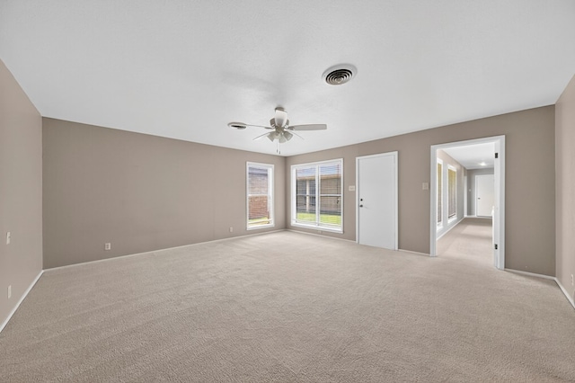 1406 W Pecan, Midland, TX 79705 - empty room featuring a ceiling fan and light colored carpet