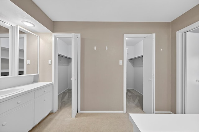 1406 W Pecan, Midland, TX 79705 - bathroom with vanity and a walk in closet
