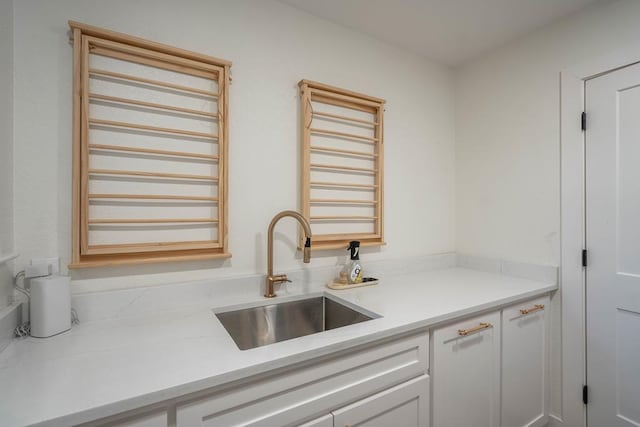 5807 Sterling Pl, Midland, TX 79707 - kitchen featuring a sink, light countertops, and white cabinetry