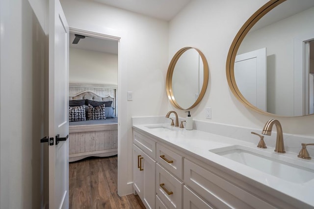 5807 Sterling Pl, Midland, TX 79707 - bathroom featuring double vanity, wood finished floors, and ensuite bath