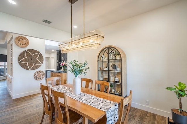 5807 Sterling Pl, Midland, TX 79707 - dining room featuring baseboards, wood finished floors, a chandelier, and recessed lighting