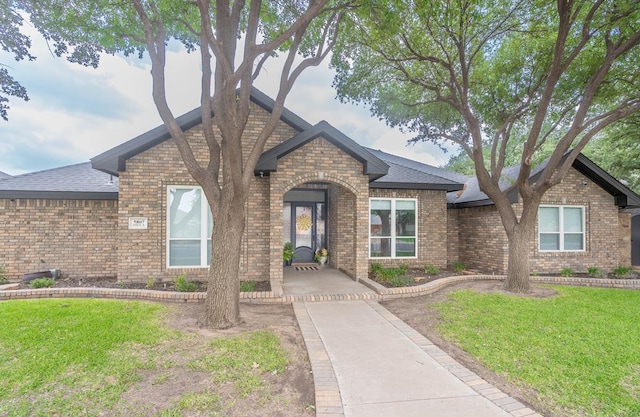 5807 Sterling Pl, Midland, TX 79707 - view of front facade with brick siding and a front lawn