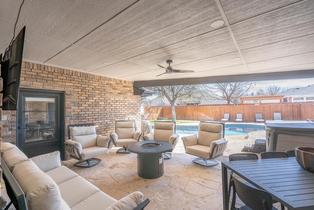 5807 Sterling Pl, Midland, TX 79707 - fenced backyard with an outdoor living space with a fire pit, a patio, a ceiling fan, outdoor dining area, and a hot tub