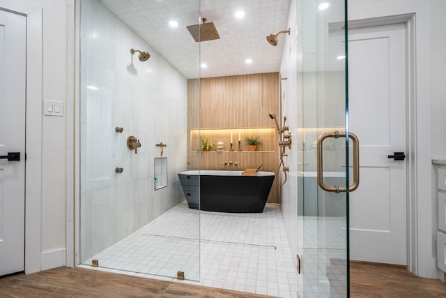 5807 Sterling Pl, Midland, TX 79707 - bathroom featuring a stall shower, wood finished floors, a freestanding tub, and recessed lighting