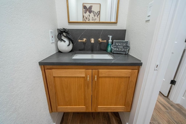 5807 Sterling Pl, Midland, TX 79707 - detailed view of a sink, a textured wall, and wood finished floors